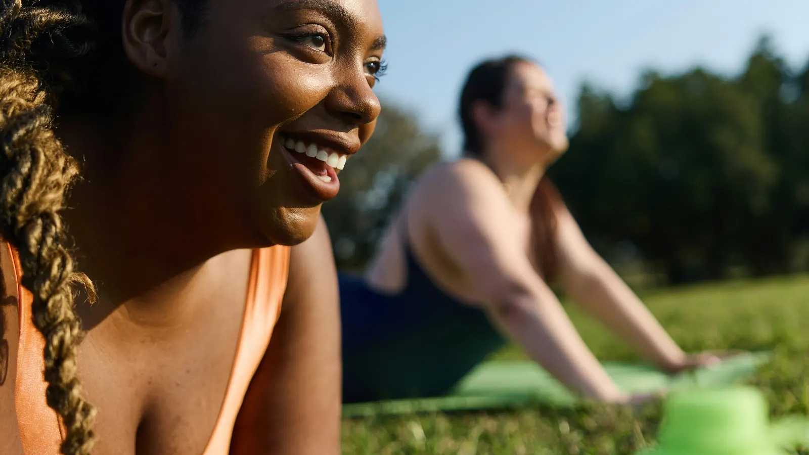 Woman relaxing on the grass outdoors with a water bottle